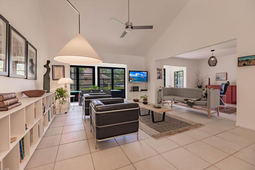 Fully renovated: modern kitchen with SS appliances and granite counters. Remodeled baths with designer tiles. New Water heater. Upgraded lighting and fans. Modern staircase and railings add to the designer look. Impact windows except the patio which is enclosed for more living space. 2Bed+Loft+Den (easily converted back to 3rd bed). Nearly turn-key with furnishings included as well as linens and kitchen items. Artwork and personal items excluded.  Community pool just steps away.  Also available is a clubhouse and  another larger pool, tennis and pickleball. Close to Tom Fazio designed golf course and beaches. Come and see this exceptional design with open spaces and high ceilings that make this feel like a single family home with less maintenance.