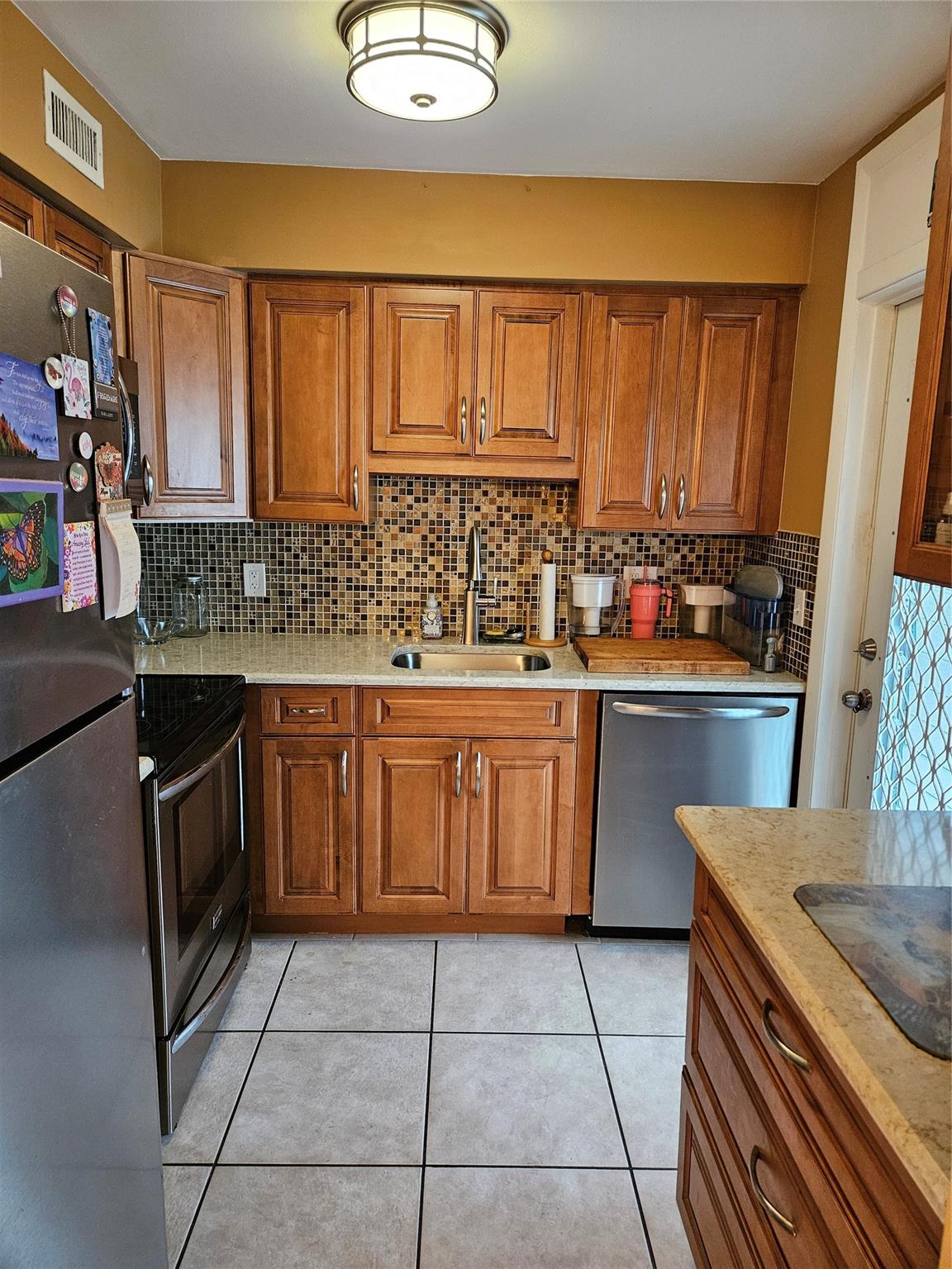Rarely available one bedroom with den unit with spectacular views of the most beautiful backyard in east Deerfield beach! Kitchen was remodeled a couple years ago with new wood kitchen cabinets, stone counters and stainless-steel appliances. All tile throughout the unit, huge 40ft screened in patio. Lots of closet space in bedroom and hallway. Park right at your front door in your assigned covered parking spot! Laundry rooms are located on 2nd and 3rd floor of bldg. Property is certified as a wildlife habitat with walking trail around the lake and heated pool located on a island with bridges for access also has a nice BBQ area and clubhouse bldg. All ages welcome, low maint fee of 326 per month-well maintained and managed property all assessments have been completed and paid already.