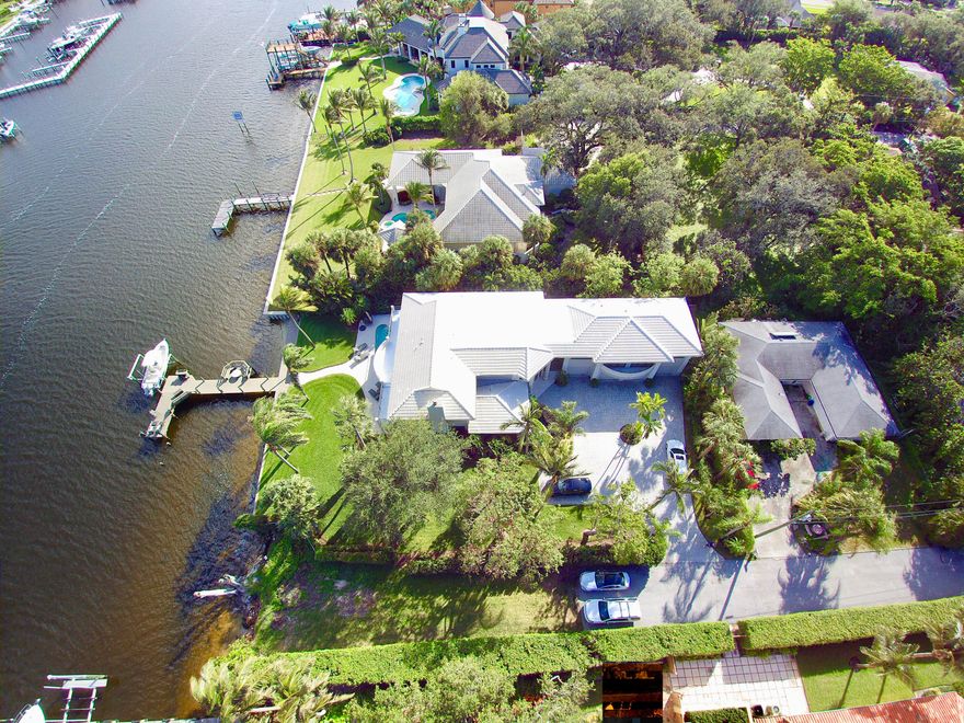 Intracoastal Oasis! This direct waterfront home has it all and more! Boaters/Car Enthusiast/Dinner Parties with lots of guests..bring them all! This gorgeous home in this amazing location has a proven track record of building beautiful family memories. The home boasts pride of ownership like none other. Spacious yet cozy. Contemporary yet warm. Beautiful finishes throughout from the Saturnia marble floors to the large granite kitchen counter tops.  All the way from the sweeping Intracoastal views to the incredible 4/5 car garage with workshop for the car enthusiast. With 6 bedrooms and 6 1/2
