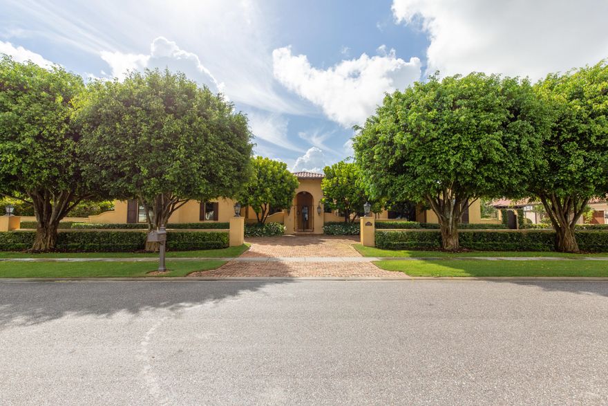 Elegant waterfront estate located in the exclusive Cypress Island of Palm Beach Polo, boasts 4 bedrooms, 6 and one half baths, 3 car garage and just under 6,000 square feet of living space. Reminiscent of a true Tuscan villa, this luxury home makes a grand impression with a courtyard entrance, soaring coffered ceilings, beautiful wide plank wood floors, and an abundance of natural light from large windows and French doors. The open floor plan boasts a state-of-the-art chef's kitchen, an airy dining room with attached rustic wine room, and a great room with a floor to ceiling stone fireplace and 3 sets of French doors leading out to the covered patio and pool area.