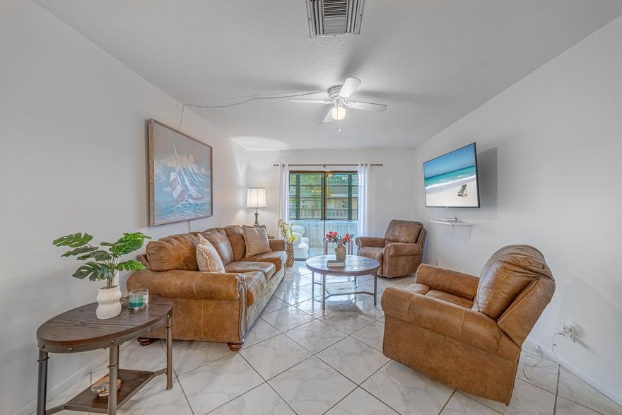 Spacious & Affordable 1-Bedroom Condo Near the Beach! Move right in to this large 1 bedroom, 1.5 bath condo being sold fully furnished. The bright, open layout features a combined living and dining area that flows seamlessly to the enclosed patio with oversized windows--perfect for enjoying your morning coffee and sunlight. Upgrades include tile flooring throughout, impact windows, updated bathrooms, a hurricane-rated front door, and in-unit washer & dryer. The kitchen offers plenty of cabinet space and natural light.Enjoy resort-style living with community amenities: pool, clubhouse, billiards, shuffleboard, grilling area and more. Condo fee covers cable, internet, water, building insurance, roof, and common area maintenance. No recreation lease!