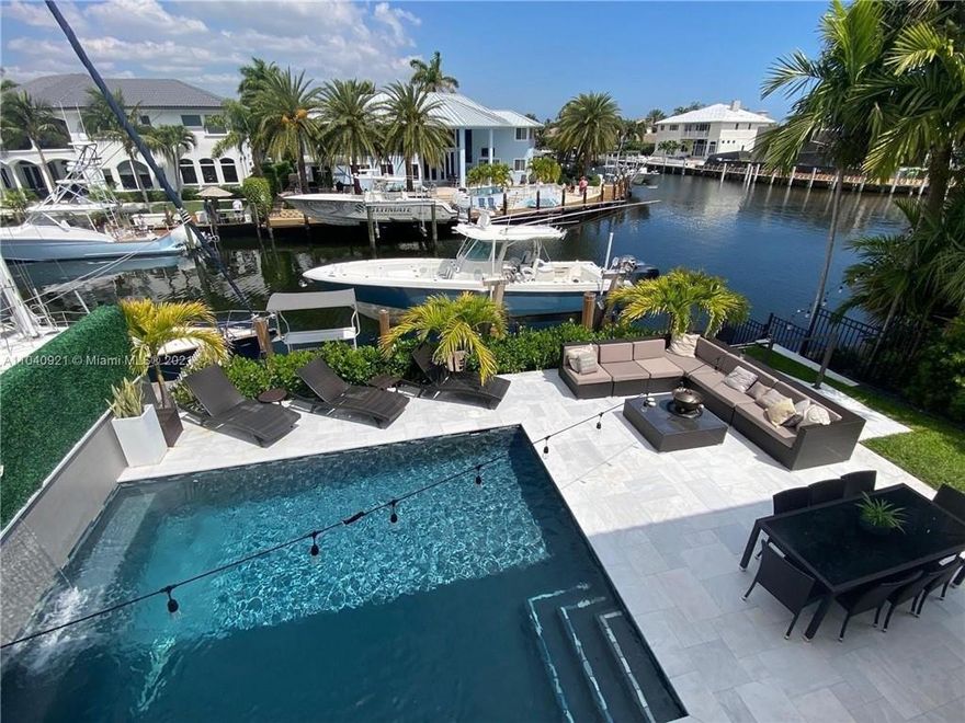 STUNNING & LUXURIOUS WATERFRONT TOWNHOUSE ESTATE! NO HOA FEE! A YACHT OWNER'S DREAM WITH A 45' PRIVATE DOCK! NEW 20,000 LB BOAT LIFT AND DOCK! MODERNLY REMODELED POOL HOME is right on E Sample Road with multi-million-dollar mansions- on deep water frontage>5-7 minutes to direct Atlantic Ocean access with no fixed bridges-This stunning MODERN custom residence offers the finest elements of modern architecture. Stunning new Chef's kitchen w/ custom cabinetry is open to the living area & overlooking the pool & water. Master bedroom & 2 additional bedroom suites are located on the 2nd level with a large balcony overlooking the pool & water-1 Bedroom located downstairs can be used for office or guest suite-Remodeled flawlessly! BETTER THAN A PENTHOUSE!! NO HOA!