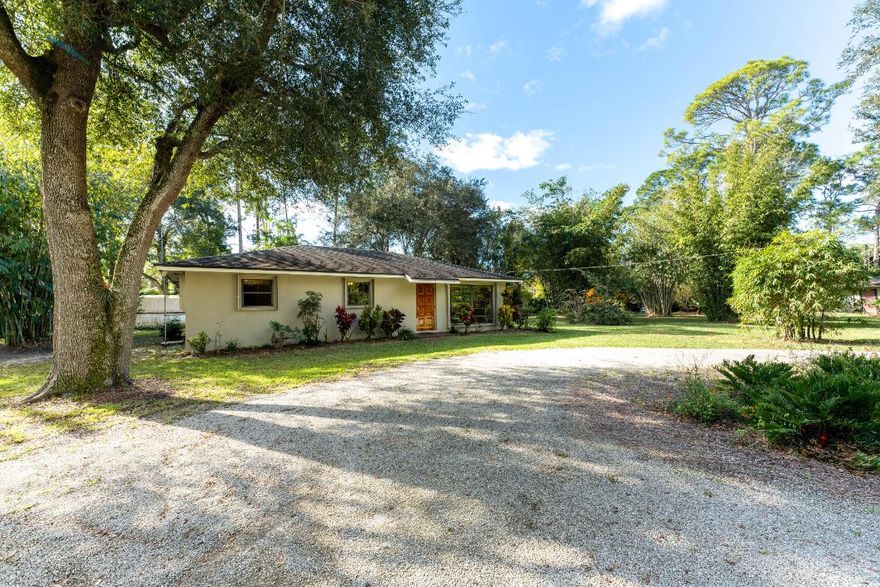 Completely private, well maintained 3/2 cbs home surrounded by a botanical garden featuring tropical palms, native trees and bushes, clumping bamboo, mature oak trees and 15+ mature fruit-bearing trees and a butterfly garden.Turnkey home has a newer septic drain field, osmosis purifying system for drinking water, accordion hurricane shutters and an additional split a/c unit in the primary bedroom.