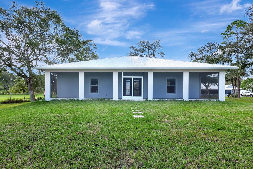 Photo of 6289 S Header Canal Road, Port Saint Lucie, FL 34987 (MLS # B26018854)