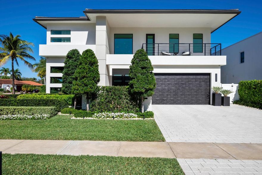 Experience refined luxury in this exceptional custom new-construction residence located in the heart of downtown Boca Raton.  Designed with meticulous attention to detail, this sophisticated home showcases bespoke finishes, cutting edge technology, and warmly curated spaces. A dramatic two-story foyer with soaring ceilings and a statement Shakuff chandelier sets the tone, leading into expansive open, living areas. The great room features a 10 foot linear fireplace with a quartzite surround and illuminated tray ceiling. The spectacular gourmet chef's kitchen is equipped with Wolf and Miele appliances, custom cabinetry, and a striking marble island and backsplash. A glamorous speakeasy bar adds both style and function, making this space truly unique. The dining area is conveniently located just off the kitchen, while floor to ceiling glass sliding doors create seamless indoor-outdoor flow, ideal for year round entertaining. The primary suite is a private sanctuary blending luxury and tranquility.  The spa inspired bathroom is a true showpiece featuring a custom floating vanity with dual sinks, expansive walk-in shower featuring two shower zones, soaking tub, exquisite marble finishes, and thoughtfully designed details. Completing the suite is a custom walk-in dressing room with illuminated display cabinetry and elegant accents offering both beauty and function in a boutique like setting.  Upstairs, a spacious loft with beverage bar is complemented by two additional ensuite bedrooms and a junior master suite. Outdoors, a private resort-style oasis awaits with a serene pool and spa featuring water and fire elements, upgraded summer kitchen ideal for dining alfresco, meticulous landscaping, outdoor shower and a dedicated enclosed dog run.  Additional highlights include full home automation, motorized shades, built-in speakers, video surveillance, generator gas line, prewire for elevator, custom white oak and glass staircase, large format limestone porcelain flooring on the first floor, and Riva white oak flooring upstairs. An additional side driveway and a finished garage with luxe pearlized epoxy floors and custom cabinetry create a spacious retreat ideal for car enthusiasts, storage, or a refined workspace. Ideally located just moments from Mizner Park, world-class dining, shopping, beaches, and parks, this extraordinary East Boca residence offers the perfect blend of modern elegance, comfort and walkable lifestyle.