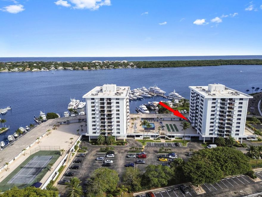 BUILDING HAS PASSED ALL CONCRETE RESTORATION AND STRUCTURAL INTEGRITY WORK; REPORTS HAVE BEEN COMPLETED AND APPROVED. Seller will pay special assessment in full at closing. Experience the ambiance of a private villa combined with the ease of condo living in this rare deck-level residence, ideally situated within the desirable, gated community of Old Port Cove in North Palm Beach. Unlike typical one-bedroom units, this unique home features a versatile bonus room perfect for a den or home office, complemented by updated vinyl wood flooring throughout.

The heart of the home is the beautifully updated kitchen, showcasing modern finishes and stainless steel appliances, flowing seamlessly into the dining and living areas. Sliding glass doors lead to a massive patioan extension of your living spaceoffering rare walk-out access directly to the pool deck and shuffleboard courts, creating a true private-resort feel.

Designed for both year-round living and seasonal enjoyment, the residence includes accordion hurricane shutters, ceiling fans, and an A/C and water heater conveniently located outside the unit to maximize interior space. The spacious bedroom offers direct deck access and abundant natural light, while the bathroom features a modern vanity and new wood-look tile.

The unit comes with a deeded garage parking space and also includes the balance of an all-systems warranty in place from January 2026 through January 2027, offering added peace of mind. Ideally located just minutes from fine shopping, dining, and entertainment, this well-maintained community offers residents a wide array of resort-style amenities.