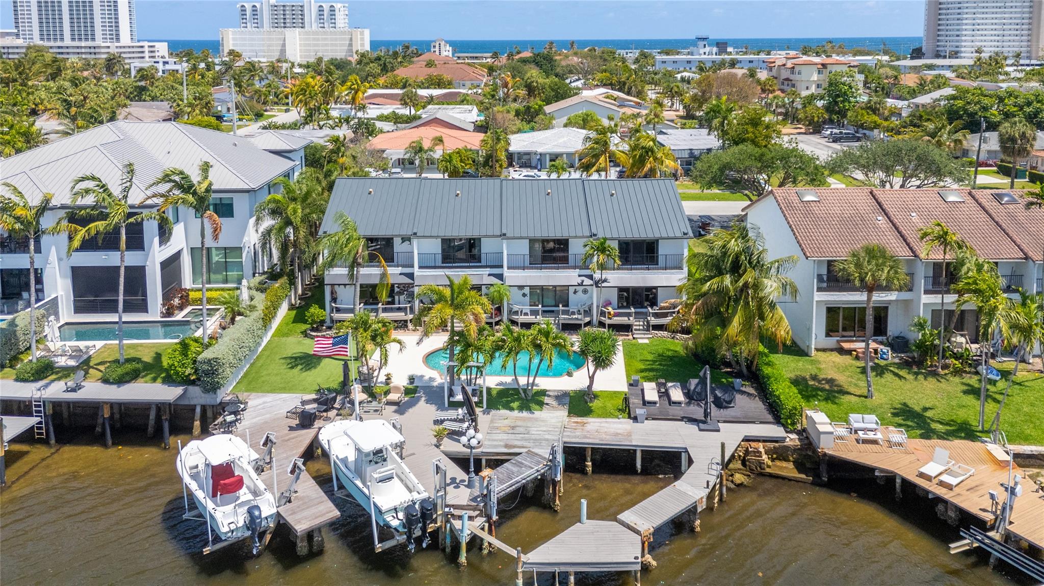 Elevate your lifestyle with this amazing waterfront unit overlooking the serene Intracoastal waterway, and captivating Capone Island nature preserve. The property is located South of East Boca Raton, a short stroll from the beach, shops, and vibrant dining options. This fully furnished 2/2.5 home features meticulously preserved original Saltillo tile flooring, spacious bedrooms with vaulted ceilings and built-in closets. Master bath offers dual sinks, a jacuzzi tub, and a step-in shower, while the second master conveniently includes a Murphy bed, transforming the space into a functional office. Enjoy the serene ambiance of your private front courtyard or unwind in the back, gazing at the continuous boat parade on the intracoastal waterway.