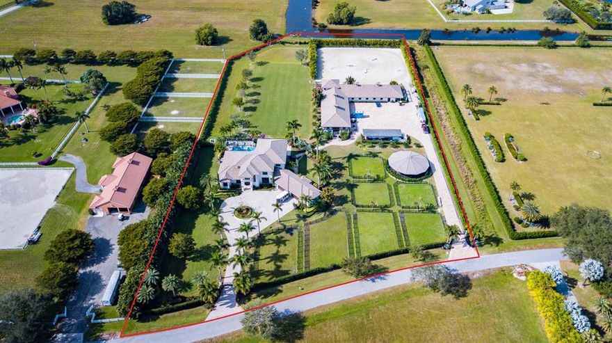 One of the best locations in all of Palm Beach Point! A professional's training facility and a luxurious dream home made for entertaining! This magnificent private 6 acre equestrian estate was originally constructed in 2011 and just renovated in the Fall of 2020. Fully equipped equestrian features paired with lavish luxury living, all just a few minutes hack to WEF, make this farm one of Wellington's crown jewels. The barn has a gorgeous rider's lounge with a pergola-covered viewing terrace, and is complete with an upstairs 2 bedroom, 1 bath grooms quarter with a full kitchen and living room.
The 2 level, custom built main house boasts 5 bedrooms + an office + media room, 8 bathrooms and a 5 car garage. The massive driveway and entrance, welcomes you into a beautiful foyer with high ceilings and views over the grassfield and pool area. You will see nothing but top quality finishes, high-end appliances and exceptional design choices in this house. The extravagant outdoor living spaces with an attractive pool and spa and amazing sunset views makes this impressive farm complete.

Main house:
***Available furnished***
(House Total: 9,050 sqft ; House Under Air: 5,697 sqft ; Lower Level Under Air: 3,945 ; Upper Level Under Air: 1,774)
6 bedroom + lg office, 6 full bath, 2 half bath house
5 car garage, with AC area
Master on main level
Viking refrigerator
Viking gas stove and hood
Viking wine fridge
Stunning pool/spa and outdoor entertaining spaces and an outdoor full kitchen, with grill and gas stove.
Two outside cabana bathrooms
Whole house generator
Impact glass throughout
Reverse osmosis water filtration system

Equest. Features:
(Barn Total: 9,061 sqft ; Barn Under Air: 1,250 sqft)
20-24 stall barn (two separate wings)
2 Barn Bathrooms
Large riders lounge with a full bathroom and a wrap-around elevated viewing terrace with pergola
Barn has upstairs 2 bedroom, bathroom grooms quarters with a full kitchen and living room.
2 tack rooms, 2 feed rooms, 7 paddocks
Grass jump field AND all-weather GGT arena!
Arena: 165' (50m) X 180'(55m) all-weather arena with GGT footing & full drainage.
Grass field: 105' (32m) wide x 275' (84m) long
Covered 6 Horse Walker (16m) from MK Horse Walkers.
Roll down aisle doors and window shutters, impact glass
Tongue and groove wood ceilings
Water, fans, flyspray to all of the stalls.
Separate Barn RO water filtration system
