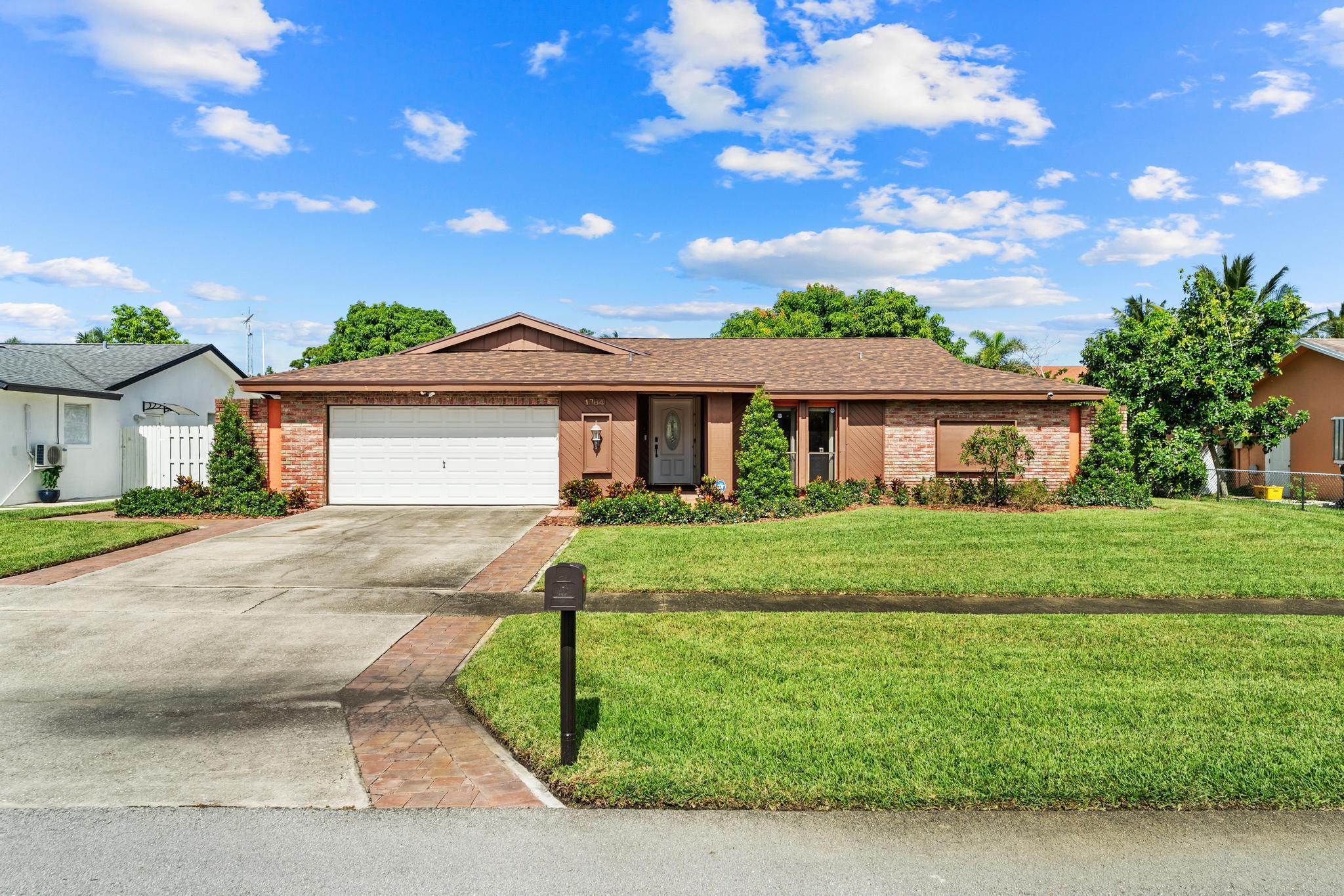 Welcome to this beautifully updated 3-bedroom, 2-bathroom home with a 2-car garage, where modern upgrades and comfortable living come together. Step inside to find stylish wood-look tile flooring throughout and a spacious layout that connects the open kitchen and dining area, perfect for everyday living and entertaining. The living room features a cozy fireplace, creating a warm and inviting atmosphere. The home has been thoughtfully enhanced between 2023 and 2024 with a brand-new roof, updated AC and handler, fresh interior paint, new baseboards, sleek recessed lighting, updated ceiling fans and patio lighting.