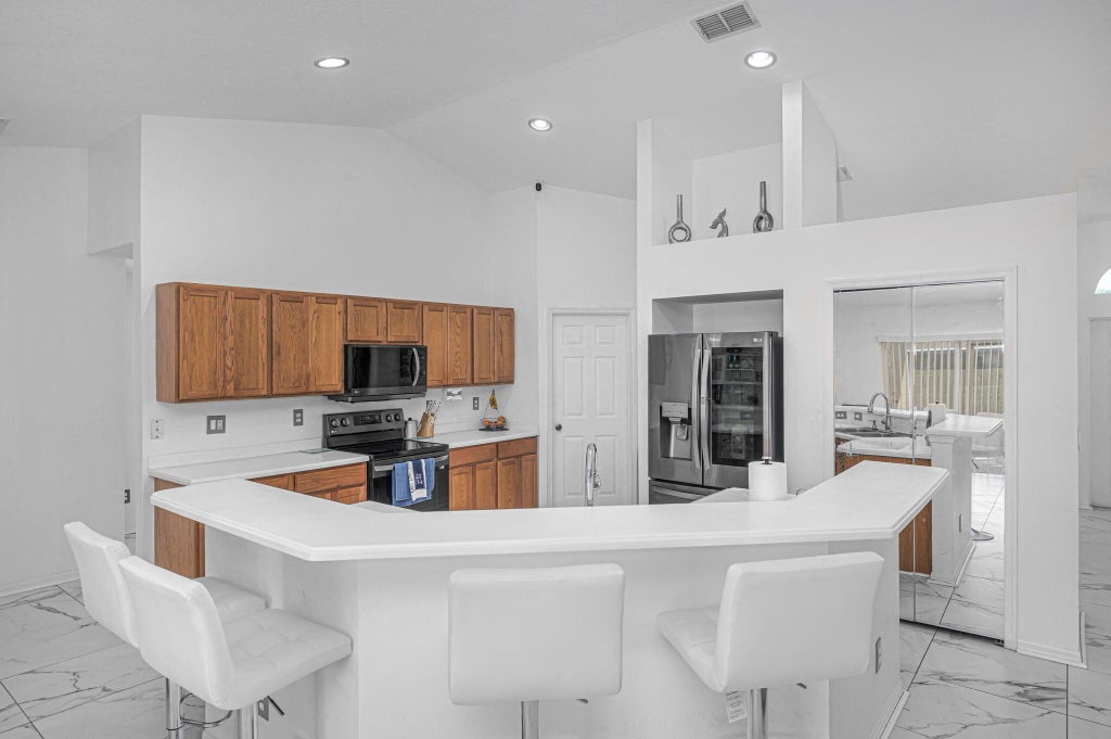 Photo of 1450 SW Leisure Lane, Port Saint Lucie, FL 34953 (MLS # R11036487)