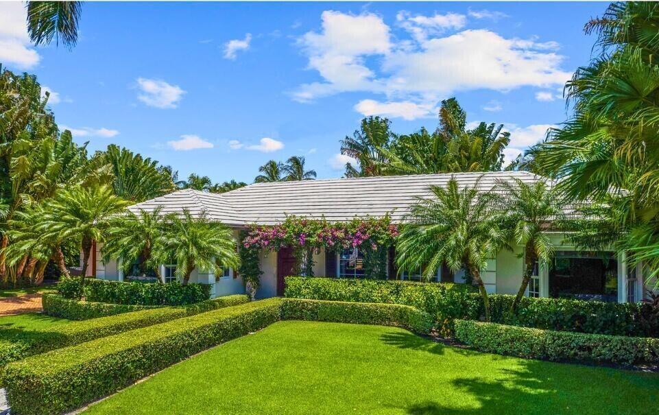 Ideally located in the north-end of Palm Beach, this four-bedroom house has been totally renovated and professionally decorated. Enter through the bougainvillea covered trellis at the front door into the large living room - perfect for intimate family gatherings or entertaining guests. From here access either the dining room or second living space / den, both of which feature glass-paneled doors that open to the backyard pool and patio. The master bedroom features his/hers sinks, tub, shower and two walk-in closets. With a chef's kitchen and breakfast nook, limestone and hardwood floors, a 400-bottle wine cellar, a large two-car garage, impact glass and close proximity to the lake trail and beach, this house has everything you're looking for in a Palm Beach luxury rental property!