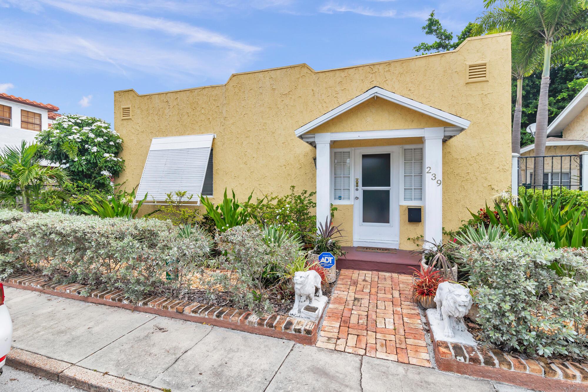 Classic 1926 Spanish Mission available for lease East of Olive near Antique Row! This historic cottage boasts classic historic details like gleaming original hardwood floors, higher ceilings, graceful arches and columns, and a gorgeous old world fireplace mantle. Lovely, covered entry with Chicago Brick walkway. Open living plan with updated kitchen with white cabinetry, granite countertops and stainless-steel appliances. Stackable washer and dryer. French doors lead to an outdoor patio. Attached garage for storage or future expansion. This is the best priced property east of Olive in the whole neighborhood.