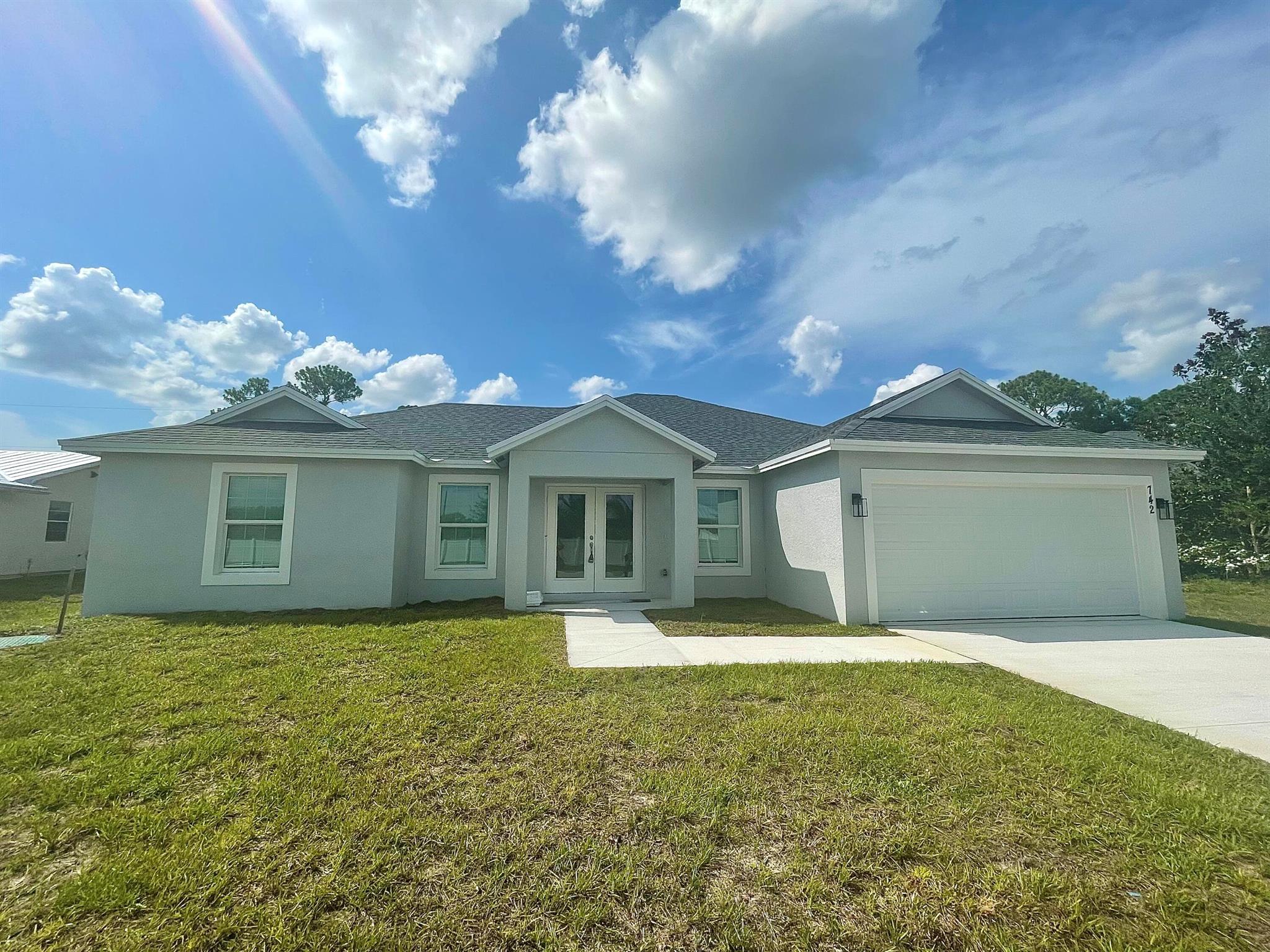 2023 NEW construction CBS home built by PSL Properties. Tiled flooring throughout with a split floor plan. Gourmet chef's kitchen with top-of-the-line stainless steel appliances & marble countertops. Upgraded light fixtures and ceiling fans throughout. Large master bedroom with vaulted ceilings, both a walk-in closet and a linen closet, two sinks and a make-up vanity and a walk-in shower. On the right side of the house, you'll find three bedrooms, one full bathroom with a large soaking tub & shower, as well as a half bathroom with additional storage. Separate laundry room off of the garage with washer and dryer hookups. Hurricane impact windows and entry doors throughout. Back patio is covered & screened in, OWNER WILL FENCE IN THE BACKYARD