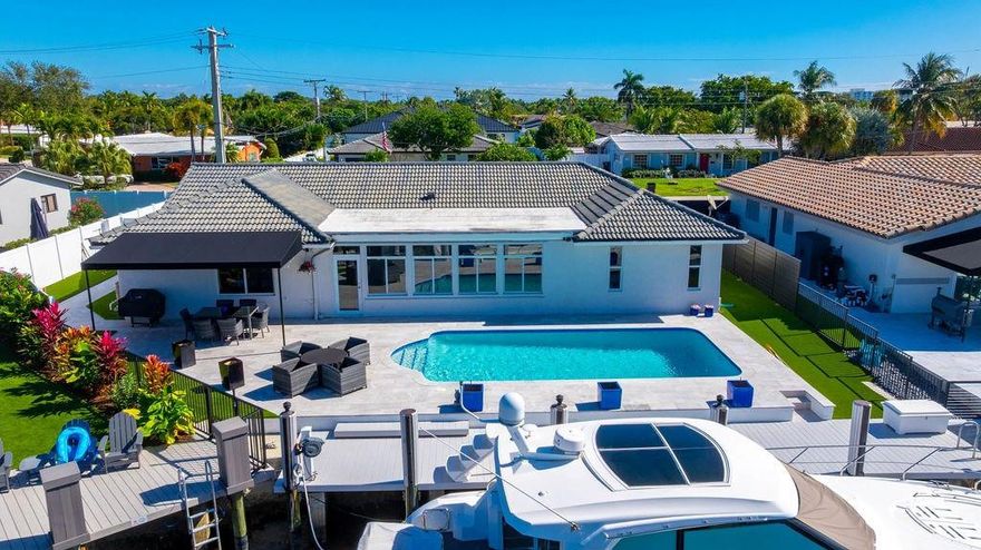 This Lighthouse Point 3 bed/3 bath home features a stunning, fully remodeled backyard designed for waterfront living. Enjoy gorgeous marble pavers, low-maintenance artificial turf, and a completely updated, raised seawall with a newer polymer dock. The current owner invested nearly $200,000 in the backyard alone. Dockage accommodates vessels up to 50 feet with no fixed bridges, offering easy ocean access. Inside, the home offers a spacious living room, formal dining room, and a desirable triple-split bedroom floor plan. Most windows are impact glass, with panel shutters on the remaining openings for full hurricane protection. An affordable opportunity to own a waterfront home in Lighthouse Point.