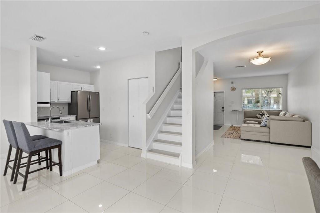 LOCATED IN A FABULOUS NEIGHBORHOOD, THIS TOWNHOUSE OFFERS AN UNBEATABLE VALUE. NO RENTAL RESTRICTIONS!!! DISCOVER THE PERFECT BLEND OF CONVENIENCE & COMFORT IN THIS STUNNING, REMODELED WATERFRONT TOWNHOME IN A GATED COMMUNITY IN THE HEART OF COCONUT CREEK! This 3-bedroom, 2.5-bath townhome has it all, featuring a modern, open floor plan with new floors throughout. The home includes a W/D, temperature range LED lighting, and boasts 9-foot ceilings. Just minutes from the Coconut Creek Promenade. Don’t miss out on this convenient, MOVE-IN READY GEM that combines modern comfort with beautiful waterfront views.