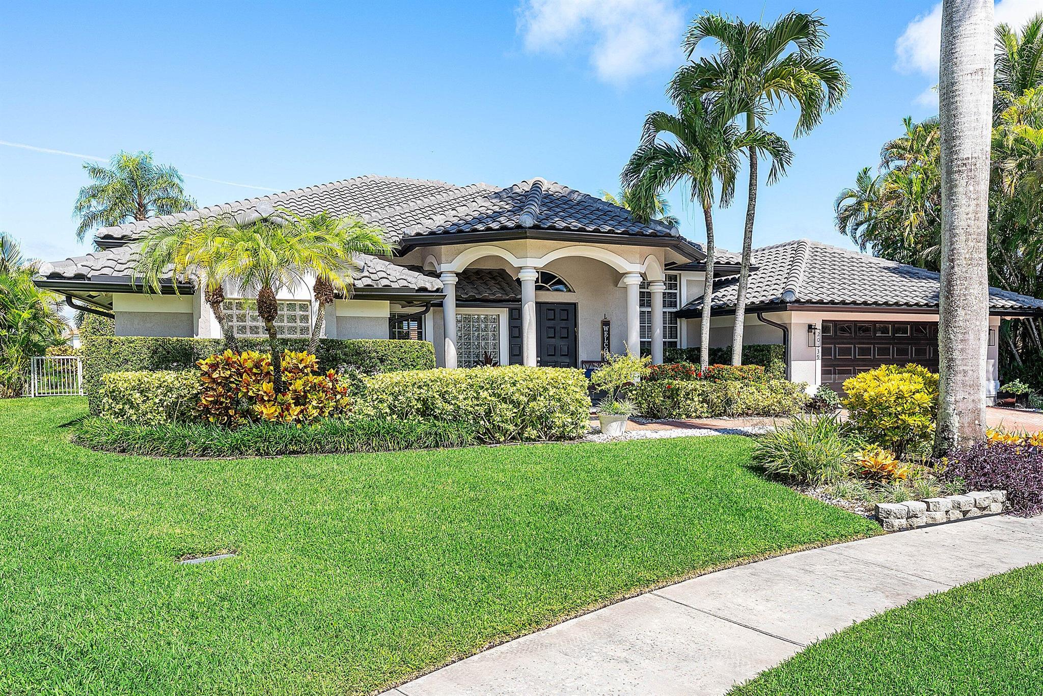 Opportunity to own this popular Cayman V model on highly sought-after oversized, pie-shaped cul-de-sac lakefront lot in gated community. Welcoming double door entry. Volume ceilings, and many updated features throughout the home, roof 2022 - come see! Spacious primary suite opening to upgraded pool and spa, adjacent bedroom can serve as study w/three more bedrooms on the other side. Generously-sized kitchen overlooks spacious family room with breakfast nook - great view of the pool! Expansive covered patio, perfect for relaxing while enjoying the stunning views of the lakefront. Convenient cabana bath. This gated community offers many amenities, including clubhouse with many activities: fitness center, resort-style pool and spa, playground, tennis and basketball courts.