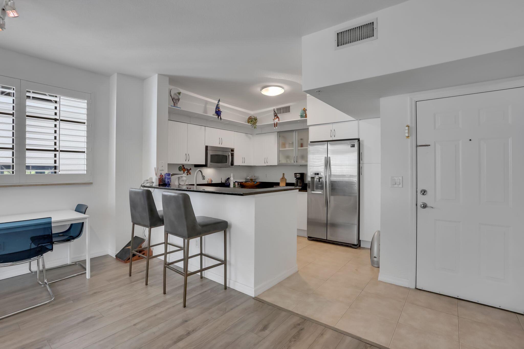 Experience refined living at Boca Grand, a full-service, pet-friendly high-rise ideally situated in the heart of walkable downtown Boca Raton. Just steps from Mizner Park and Royal Palm Place, this coveted address places you amidst the city's finest dining, luxury shopping, vibrant entertainment, and only one mile from the beach.This rare corner two-bedroom, two-bath residence is one of only four in the building to feature a dedicated laundry room. Designed with an open-concept floor plan, it offers seamless living and dining spaces, a spacious primary suite with walk-in closet, and durable designer flooring throughout. Floor-to-ceiling impact windows and sliders invite natural light while opening to a covered patio with serene city views--without the bustle below.Residents of Boca