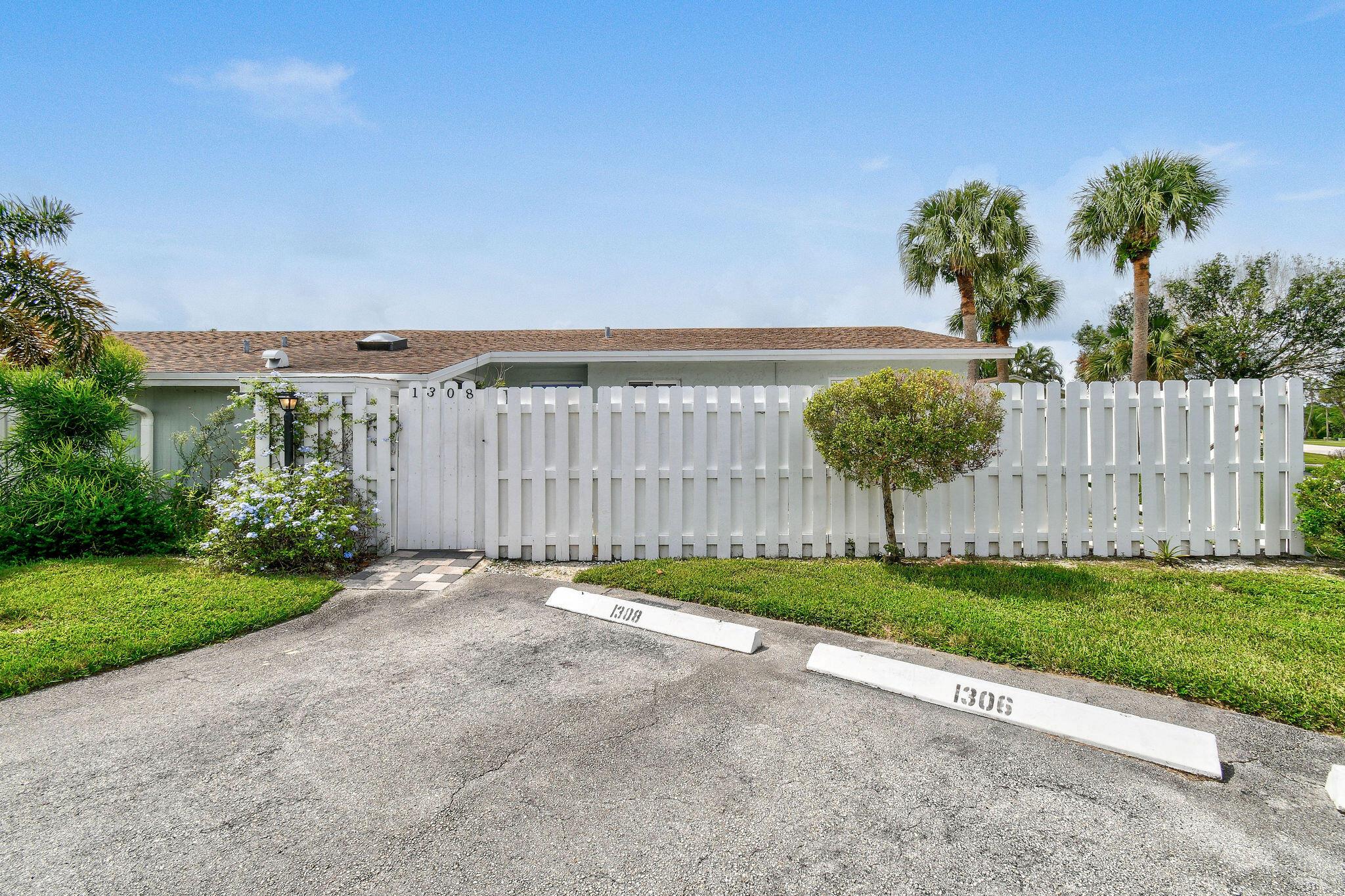Discover this beautifully updated 3-bedroom, 2-bathroom unit, featuring a fenced private patio entrance and a serene backyard patio. This home boasts high-end finishes, with elegant wood flooring throughout the living areas and crown molding for a touch of sophistication. Enjoy the convenience of an in-unit laundry room. The community offers fantastic amenities, including a pool and clubhouse, and is ideally located just 10 minutes from the beach.