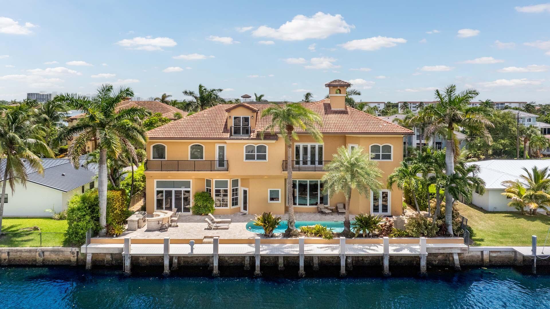 Welcome to 929 Banyan Drive, a home that blends timeless craftsmanship with the ease of waterfront living. Set on 90 feet of deepwater frontage in the desirable Delray Beach enclave of Tropic Isle, this substantial residence offers five bedrooms plus a private office, three-car garage, and a dedicated home theater. The well-appointed kitchen, designed for both function and style, opens seamlessly to a spacious family room, creating the heart of the home. Expansive windows and outdoor living areas frame tranquil water views, while solid construction and thoughtful design ensure comfort, privacy, and lasting quality. Perfect for boating, entertaining, or simply relaxing by the water, this home offers a refined yet welcoming lifestyle in an exceptional location.