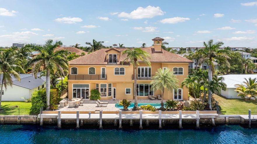 Welcome to 929 Banyan Drive, a home that blends timeless craftsmanship with the ease of waterfront living. Set on 90 feet of deepwater frontage in the desirable Delray Beach enclave of Tropic Isle, this substantial residence offers five bedrooms plus a private office, three-car garage, and a dedicated home theater. The well-appointed kitchen, designed for both function and style, opens seamlessly to a spacious family room, creating the heart of the home. Expansive windows and outdoor living areas frame tranquil water views, while solid construction and thoughtful design ensure comfort, privacy, and lasting quality. Perfect for boating, entertaining, or simply relaxing by the water, this home offers a refined yet welcoming lifestyle in an exceptional location. All images and visual materials associated with this property, including AI generated images, virtually staged photos, edited images, artist conceptual renderings, maps, site plans, floor plans, and other graphics, are provided solely for illustrative purposes. These representations may not accurately reflect current conditions and are subject to change without notice. No representations or warranties are made regarding the accuracy or completeness of these visual materials. Buyers should not rely solely on these materials and are responsible for independently verifying all property details.