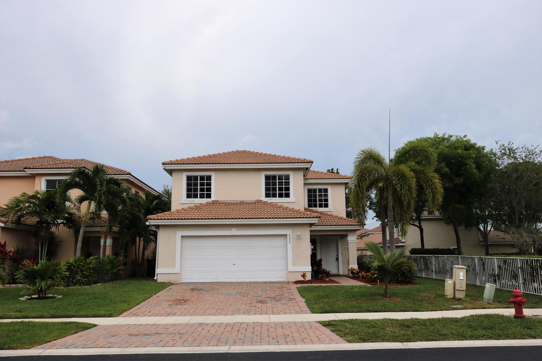 Beautiful Two Story Single Family- in a Gated Community, 4 Bedrooms, 2 Baths and half, 2 car garage. New floors, freshly painted and more. View over the Magnificent Lake. Ready to move in!