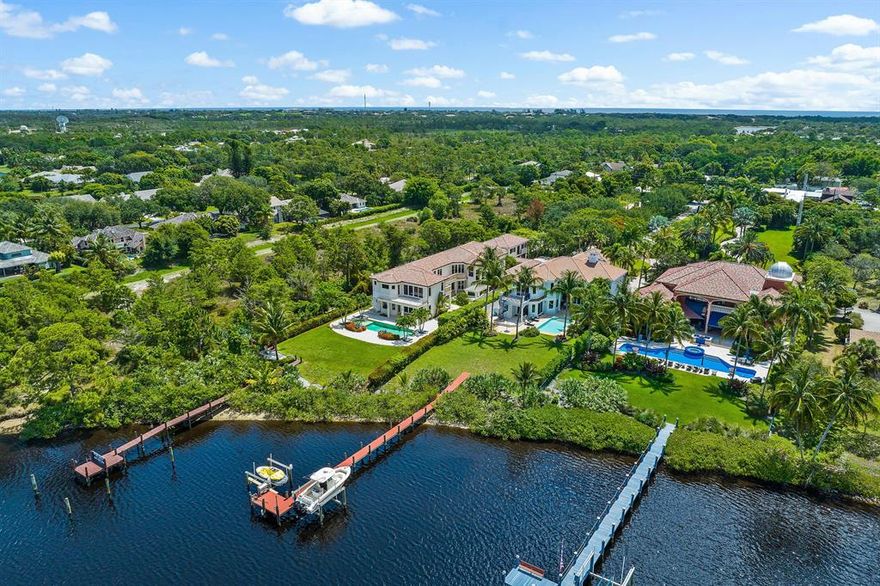 Treat yourself to the life of luxury and elegance you deserve with this spectacular riverfront custom estate built with the finest materials set on 1.1 acres of land. Anyone who appreciates flawless architectural design will fall head over heels for this remarkable residence. From the moment you arrive, the gated entry instantly sets the tone for this prestigious abode. At the same time, the long driveway builds anticipation as you admire the landscaping and approach the home. Here, a grand and stately entry invites you to step inside and explore the 5 bedroom 7.5 bath layout with a selection of sophisticated living spaces that can be adapted to your needs and lifestyle. The kitchen is complete with stone countertops and Downsview wood cabinetry. There are two islands and a raised