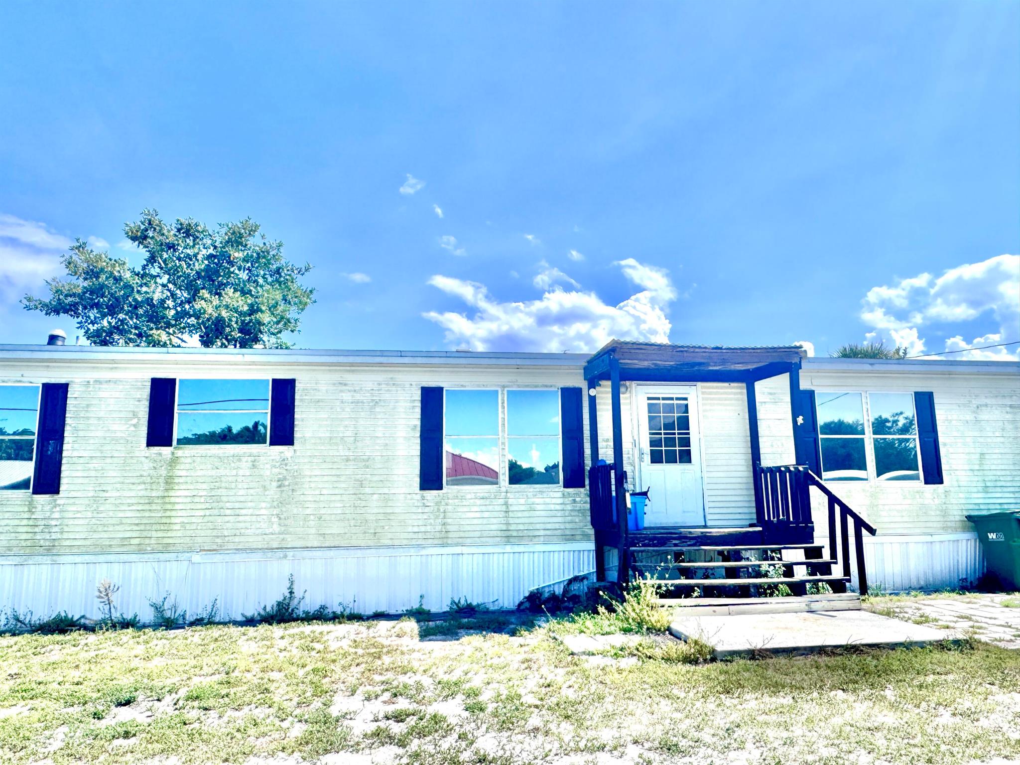 This huge Palm Harbor mobile home on almost a half acre corner lot is ready for its new owners. With 4 bedrooms and 2.5 bathrooms, it's big enough for the whole family. It has a living room AND family room in a split floor plan set up. The laundry room has a half bathroom and comes with the washer and dryer. It has a gas stove and gas on-demand water heater. The roof was installed only a couple years ago and the AC has been upgraded to a 4 ton. The master bedroom has an additional sitting room/office/nursery attached and comes with a large soaker tub plus stand up shower. With some minor TLC, this home is perfect for anyone! Partially fenced back yard with 2 sheds.