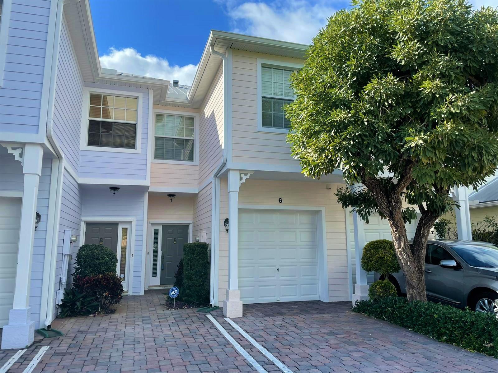 Live close to the beach in this beautiful Key West-style townhome in Pineapple Village South.This 3-bedroom, 2.5-bath home with a garage offers an open floor plan designed for entertaining. The kitchen features wood cabinets, a pantry, granite countertops, and a brand-new stainless steel refrigerator and stove.Enjoy peace of mind with impact windows in the bedrooms, plus upgraded bathrooms, ceramic tile on the first floor (and even in the garage), bamboo flooring on the stairs and upstairs hallway, and a central vacuum system. Plantation shutters throughout add a stylish touch.Pineapple Village South is a quaint, private community of only 9 townhomes, ideally located near downtown Lake Worth, the Intracoastal, and just a 10-minute walk to the beach and park.