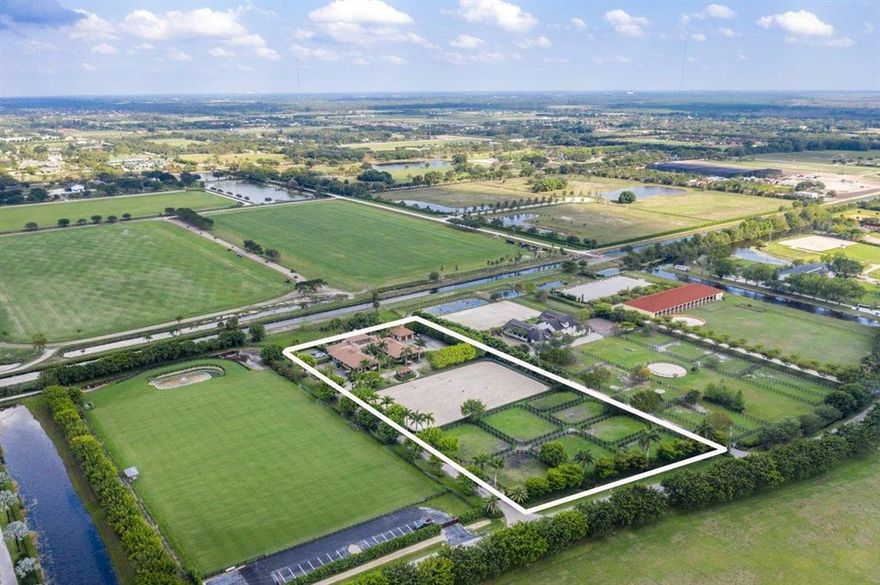 Magnificent, gated property is situated on just over 5 acres and features a 20-stall barn and residence, riding arena, and
7 paddocks. The barn's U-shape design features wide cobblestone aisle ways, vaulted wood paneled ceilings with
recessed lighting, 20 stalls, 4 hot & cold wash stalls, a large tack room, and a garden courtyard. The expansive
150' by 250' riding arena features all-weather footing and is accompanied by a covered and elevated viewing deck.
The recently renovated main-floor owner's quarters features a living area, dining room, fireplace, screened and covered lanai, and a pool area with a spacious Travertine tile deck
and tropical landscaping. An elegant center staircase in the courtyard leads up to the second level manager's quarters,
which offers a spacious deck *con Magnificent, gated property is situated on just over 5 acres
and features a 20-stall barn and residence, riding arena, and
7 paddocks. The barn's U-shape design features wide
cobblestone aisle ways, vaulted wood paneled ceilings with
recessed lighting, 20 stalls, 4 hot & cold wash stalls, a large
tack room, and a serene garden courtyard. The expansive
150' by 250' riding arena features all-weather footing and is
accompanied by a covered and elevated viewing deck.
The recently renovated main-floor owner's quarters features
a living area, dining room, fireplace, screened and covered
lanai, and a pool area with a spacious Travertine tile deck
and tropical landscaping. An elegant center staircase in the
courtyard leads up to the second level manager's quarters,
which offers a spacious deck with a pergola and a bird's eye
view of the grounds. Other features include a detached garage,
an abundance of parking space, and a paved driveway
entrance with automatic gates and lush landscaping.