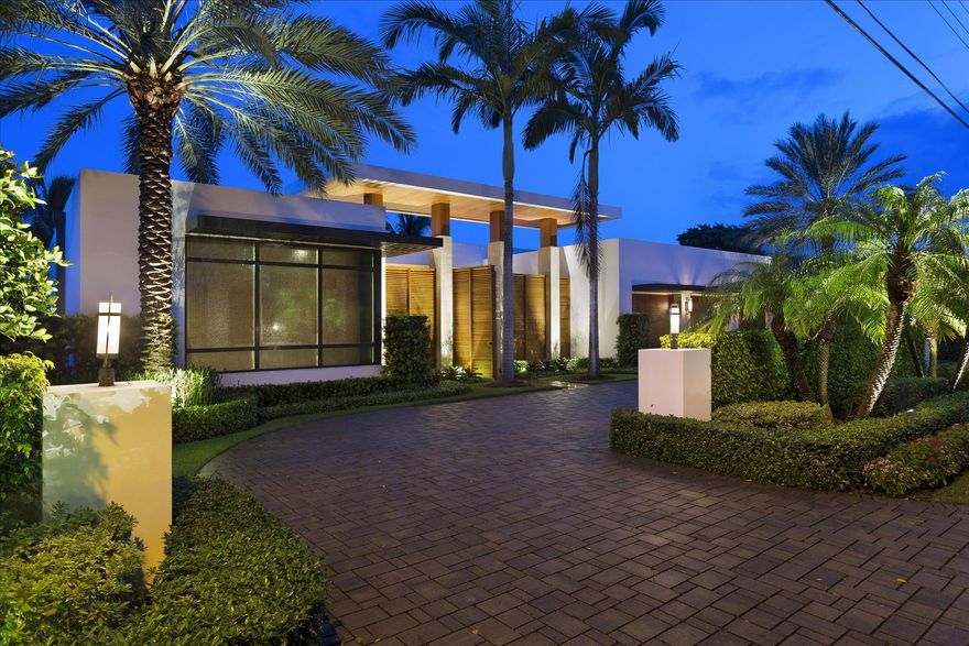 This striking modern estate fronts 100+/- feet on the Intracoastal Waterway, capturing scenic water views and sunsets across lush lawns extending all the way to the shoreline.  Glass walls join the interiors to the waterfront lanai and ipe platform decks with a fire-pit by the sleek pool and spa outlined in pebble-stone finishes.  The rock water wall is itself a work of art.
