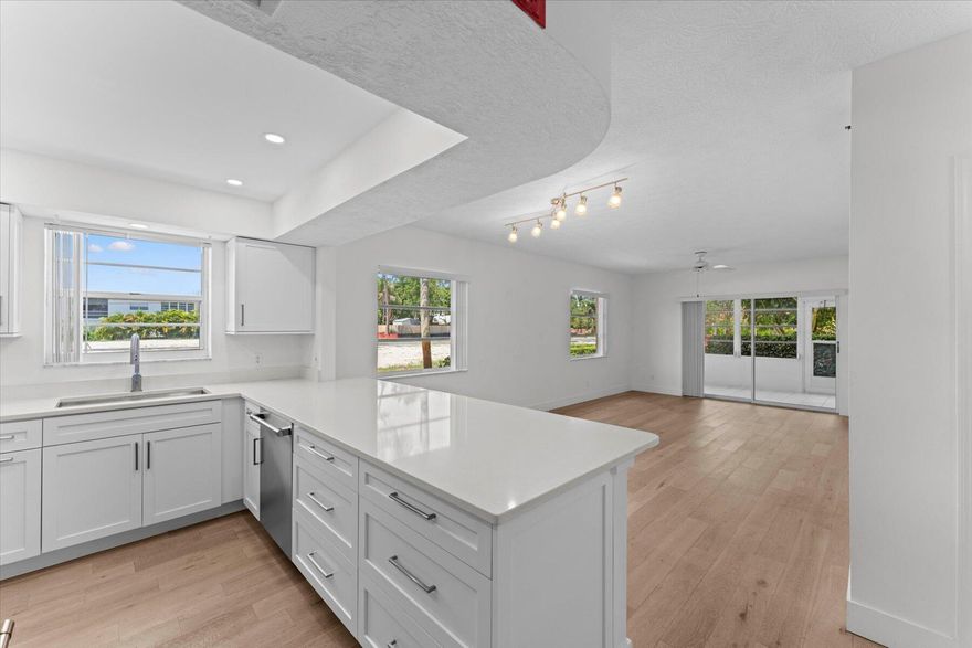 Welcome to this exceptional FIRST-FLOOR CORNER unit, fully REMODELED with $70k in premium upgrades. This beautifully designed 2-bedroom, 2-bathroom home boasts a completely new kitchen featuring top-of-the-line Monogram appliances, custom cabinetry, and sleek quartz countertops. The master suite offers a spa-like en-suite bathroom with contemporary fixtures and sophisticated tiling. Enjoy added convenience with a brand-new washer and dryer, and the privacy of a corner unit with easy access and a designated covered carport space. Located in a vibrant and active 55+ community, this home offers fantastic amenities, including a pool, clubhouse, shuffleboard, and a putting green. Plus, this unit is just a short walk to the clubhouse and all community activities.