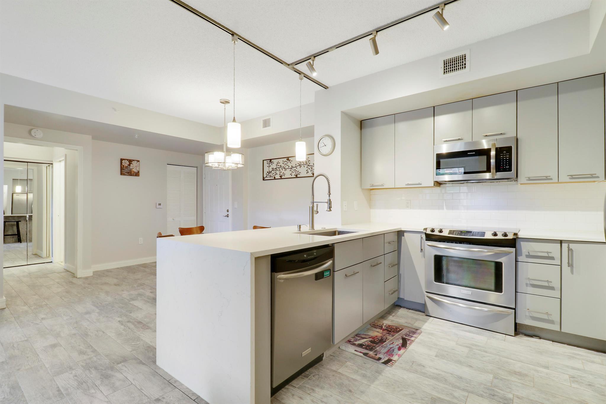 Beautiful Corner Unit in The Courtyards at City Place Discover this stunning two-bedroom, two-bathroom corner condo in The Courtyards at City Place, offering an abundance of natural light thanks to extra windows that brighten every room. The modern kitchen features sleek quartz countertops with a stylish waterfall finish, complemented by wood-look tile floors throughout for a contemporary yet warm feel. This move-in-ready home is perfect for those seeking convenience and comfort.