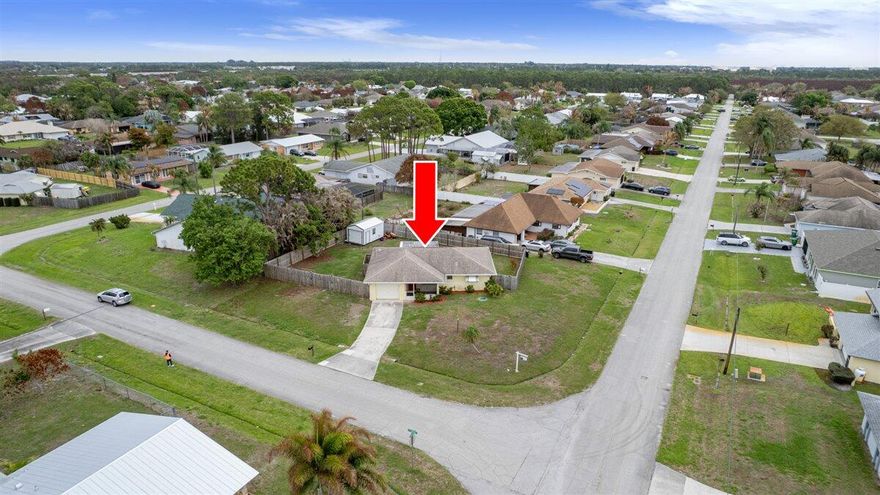 Welcome to this charming Port St. Lucie retreat! Offering rare outdoor space and privacy that far exceeds the neighborhood standard with a fully fenced in corner .29-acre lot and inviting covered front porch or retreat to the spacious covered back porch, perfect for shaded afternoon gatherings or morning coffee. Peace of mind comes built-in with a 2016 roof and CBS construction, while the home's design perfectly captures the Florida lifestyle. This well-maintained 2-bedroom, 2-bathroom home features a functional layout, updated bathrooms, fresh paint throughout, and tile floors in main areas. Just minutes from boat ramps and Crosstown Parkway, it's the perfect blend of comfort and convenience. Whether you need room for a pool, garden, or boat storage, this oversized lot delivers.