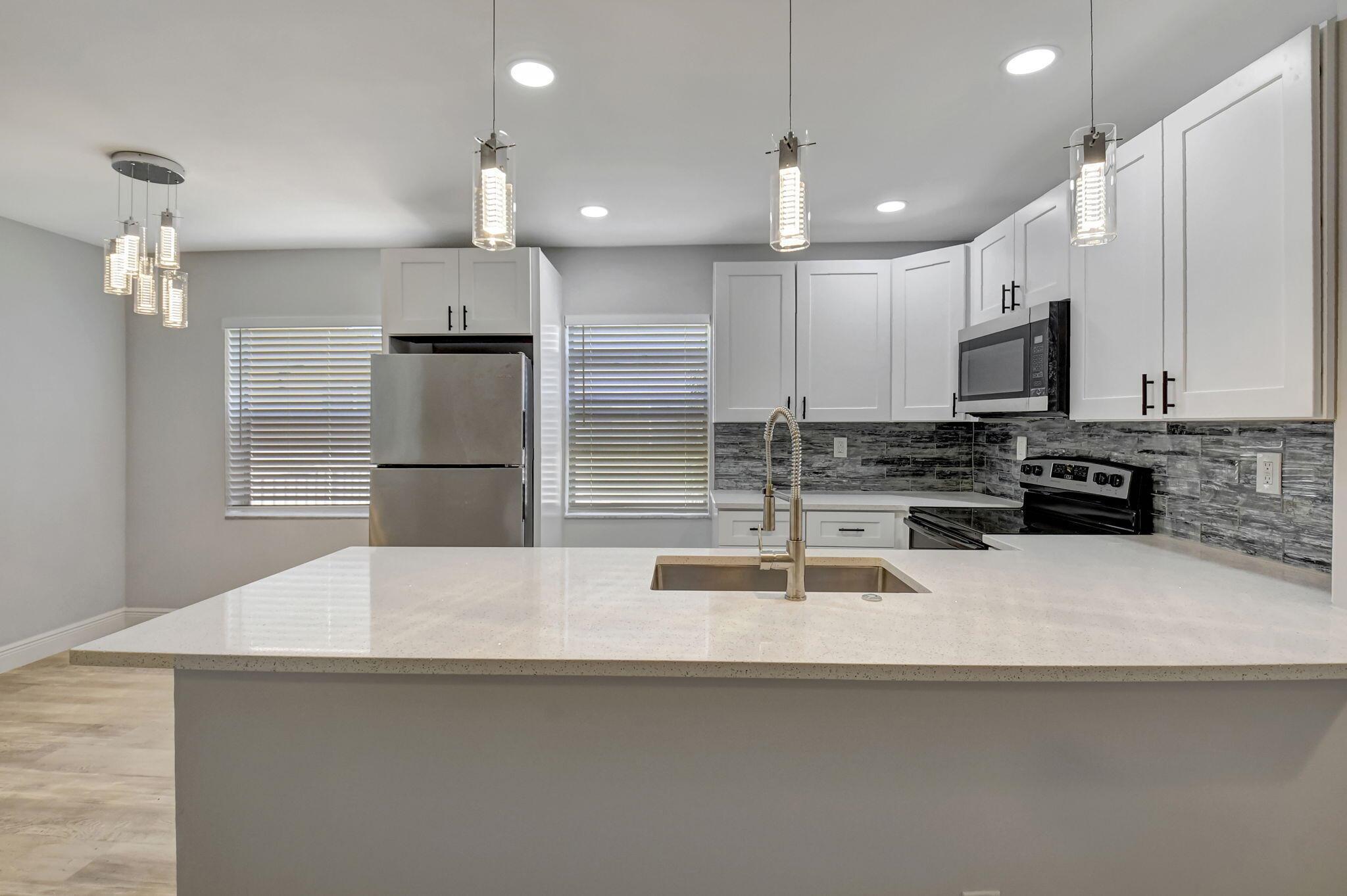 Welcome to your luxurious retreat nestled in the heart of Kings Point, Delray Beach's premier 55+ comminity. This stunning condo boasts all new construction with impeccable designer finishes, offering a blend of elegance and comfort. Step into a haven of modern living with brand new appliances adorning the sleek kitchen, perfect for culinary enthusiasts. The spacious living area features luxury vinyl waterproof and soundproof floors, providing both style and practicality. Relax and unwind in the tranquility of your private sanctuary, or indulge in the array of amenities offered by the esteemed Kings Point community. Don't miss the opportunity to experience resort-style living at its finest in this meticulously crafted condominium!