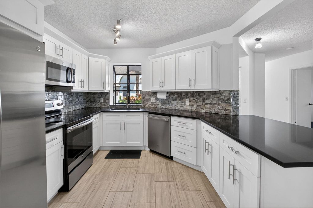 Photo of 5259 Europa Drive #D, Boynton Beach, FL 33437 (MLS # B26027733)