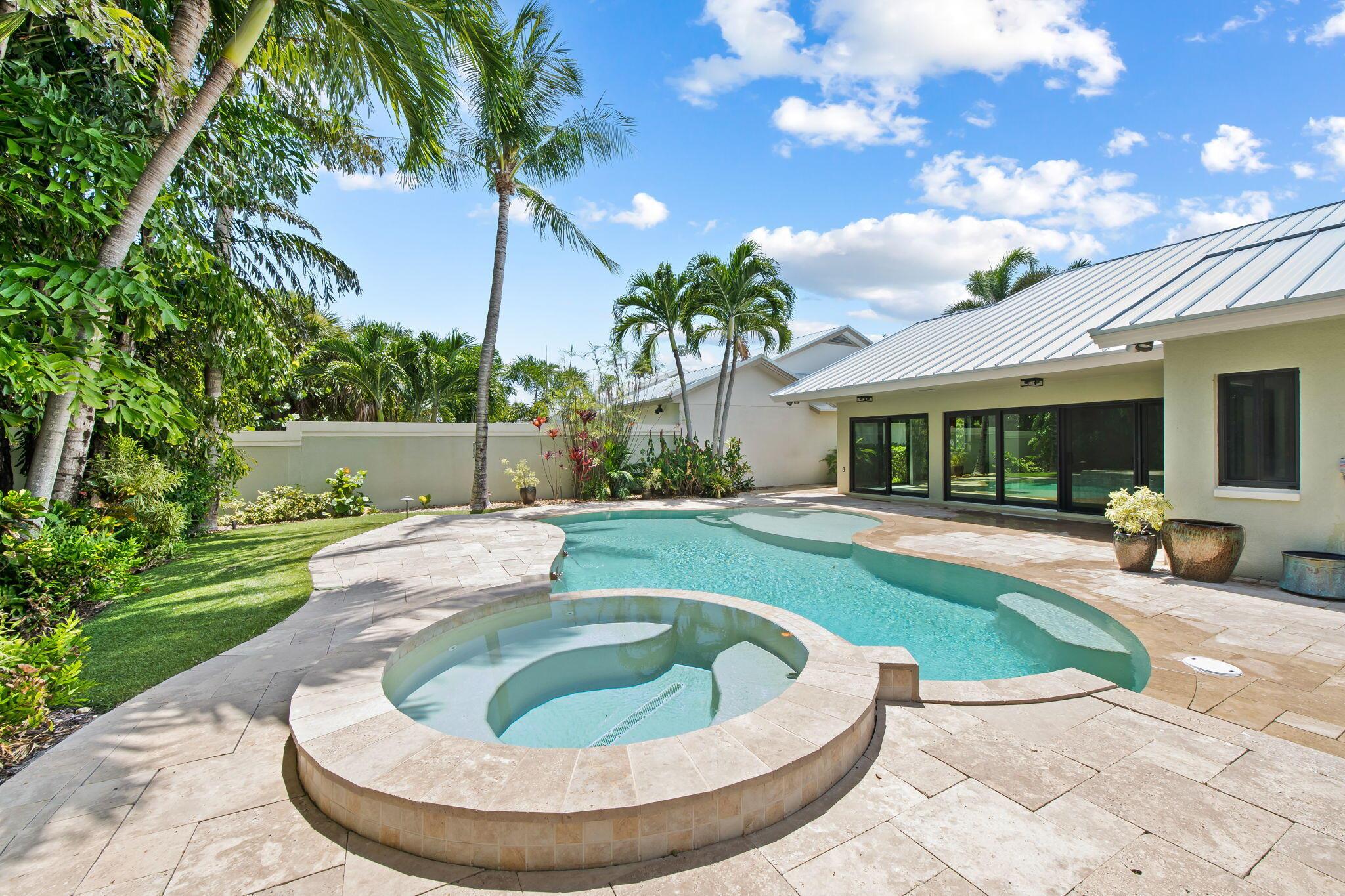 STEPS TO THE BEACH! This single-story home on an OVERSIZED LOT features a PRIVATE FREE-FORM SALTWATER POOL & SPA with MULTI-COLOR LIGHTING and a BACKYARD FACING EAST to capture refreshing SOUTHEAST OCEAN BREEZES with TOTAL PRIVACY--your own backyard Private Oasis just minutes away from the ocean. Major updates include NEW METAL ROOF WITH 30 YEAR WARRANTY, IMPACT WINDOWS & DOORS, and a NEW HURRICANE GARAGE DOOR. Inside, enjoy VAULTED CEILINGS, SPLIT FLOOR PLAN, 3 BEDROOMS & 2 BATHS, and a chef's kitchen with WOOD CABINETS, GRANITE COUNTERTOPS & STAINLESS-STEEL APPLIANCES. Community offers CLUBHOUSE, TENNIS & PICKLEBALL, plus an active social lifestyle-all in The Ridge at the Bluffs, one of Jupiter's most sought-after neighborhoods. 141 Sand Pine Drive - Florida coastal living at its best