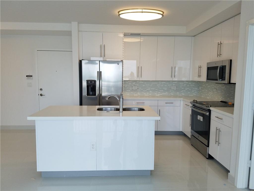 Luxury Condo in Aventura Place. 2 bed/2 bath + Den. 2 assigned parking spaces in open courtyard in the center of the complex. Luxury Italian kitchen with wood cabinetry, quartz counter tops, s.s. appliances, 24" porcelain white floors throughout, luxury vinyl just installed in the 2 bedrooms. Split floor plan unit with lots of natural light. 1 balcony where you can relax and enjoy beautiful sunsets from and a community pool. Walk in closets. Stacked washer/dryer included in the unit. High impact windows & doors. Walking distance from "Waterways", best public school in Aventura K-8 rated A school, House of Worship, close to Aventura Hospital and Aventura Mall, Gulfstream and US1. Brightline and Coastal Link, just a few steps away. Rent includes water, alarm and high speed wi-fi.