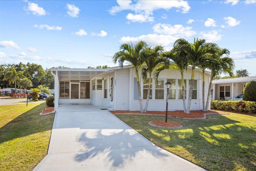 Beautiful 2 bedroom, 2 Bath home on a corner lot in the desirable Savanna Club 55+ community. Home features a split plan with a living room/family room layout, large island kitchen and formal dining room ideal for entertaining, a 38' enclosed tiled lanai, covered carport plus a 1 car garage, accordion shutters, updated flooring, appliances and more! Priced to sell, this home is an incredible value for those seeking full or part time living. All measurement approximate, buyer to verify. Land Lease Property