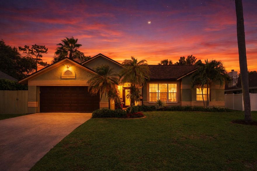 WELCOME HOME TO DESIRABLE WOODS WALK...a walkable golf cart friendly community close to all things western Lake Worth and Wellington have to offer. BRAND NEW ROOF! Lovingly cared for 3/2 POOL home with converted garage space that adds a 4th bedroom/flex room for family living. The REMODELED kitchen and baths, stone wood burning fireplace, and family room addition with tongue & groove pine ceilings & new skylights add charm and warmth year round. A dream backyard designed for relaxing or entertaining depending on your mood is complete with tiki bar, covered lounge area, grill station and EXTRA green space to play or sit by the firepit just outside the gate. IMPACT WINDOWS AND DOORS in the front.  A-RATED schools. Mature landscaping, canal view, generator ready. LOW HOA. GRAB THIS BEAUTY! Common areas include basketball, tennis, pickleball, playground, and sidewalks. This home sits at the quiet back end of Woods Walk. Discovery Key Elementary is less than a mile away. Emerald Cove Middle is just as close. A few miles west opens up Wellington's full recreational ecosystem — soccer, baseball, football, lacrosse, basketball, community center, and polo. From this address you access all of it without paying Wellington property taxes. Date night at Bonefish Grill. Saturday morning at Brooklyn Bagel.  THE KITCHEN AND THE HOUSE Split floor plan — primary suite on one side, secondary bedrooms on the other. Three dedicated living spaces include a formal living room at the front of the home, the additional family room/game room off the back, and a greatroom with a fireplace off the kitchen. The kitchen was built by a local craftsman specific to this space — all solid wood, soft-close doors and drawers, custom paint matched to the primary bath, large granite island that serves as an eating bar, patterned tile backsplash also done by a local craftsman, globe pendant lighting, and a large pantry. GE slate appliances throughout. The primary suite runs a full 10-foot ceiling with custom crown molding. The primary bath features double sinks, custom solid wood cabinets built to the space, granite countertops, and a custom glass door shower — bright and well done. Both bathrooms were fully upgraded with custom features. The two secondary bedrooms run at 8-foot ceilings. The fourth bedroom was converted from part of the garage — started as a nursery, became a playroom, then an office, now a quiet comfortable bedroom with its own window and closet. The conversion also created a proper indoor laundry room with storage —The garage still accommodates one vehicle and has upper and lower cabinets, a workbench, large refrigerator, and hanging storage racks overhead. The attic above has standing room throughout — real storage, seasonal bins, accessible by ladder from the garage. Wired smoke detectors on both sides of the house, outside each sleeping area. Some furniture inside can be negotiated as part of the sale. Tiki bar, tiki hut, gazebo, two large storage boxes all remain with the home. THE SYSTEMS New roof installed three months ago — shingle and flat deck both replaced, with all new gutters and downspouts. All exterior windows replaced with upgraded PGT windows. Front of home upgraded to impact hurricane windows including the living room and primary bath, so the home stays light during a storm and shutters aren't required on the front. Front entry door, side garage door, and overhead garage door are all hurricane rated. Generator hookup in place. Mini-split AC in the addition — independent, efficient, a few years old. Main AC unit serviced regularly and confirmed efficient by technician. Water heater approximately four years old. The salt pool has a newer cell to generate high quality chlorine for no chlorine smell or salt taste. The pool is well designed with a seated table area for four, sun shelf with bubbler, and umbrella holder, as well as, a brand new automatic pool cleaner. The deep end is 7ft. rather than a traditional 6ft. Electric averages approximately $270/month. City water averages $70/month. Homeowners insurance approximately $2,997 annually. HOA $73.43/month. SCHOOLS AND GETTING AROUND Discovery Key Elementary and Emerald Cove Middle are both less than a mile away and well-rated. For high school, Dr. Joaquin Garcia is the zoned option — Joe DDimaggio Childrens hospital and Wellington Regional are just ten minutes away. Five minutes to the Turnpike and easy North South travel. Wellington Mall is five minutes away. Downtown Lake Worth Beach twenty minutes east. PBI twenty minutes. WHO BUYS THIS HOME Buyers who've been looking in Wellington and keep hitting a wall on price. Anyone who wants waterfront without lakefront premiums. People who want a neighborhood where they can walk to dinner, ride to the grocery store, and use the recreational infrastructure of one of Palm Beach County's best communities without paying for the zip code.