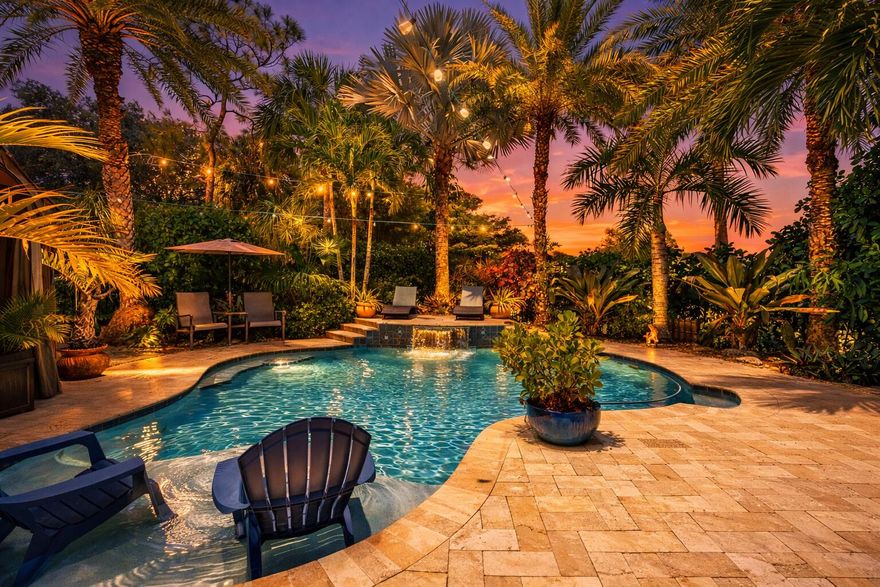 WELCOME HOME TO DESIRABLE WOODS WALK...a walkable golf cart friendly community close to all things western Lake Worth and Wellington have to offer. BRAND NEW ROOF! Lovingly cared for 3/2 POOL home with converted garage space that adds a 4th bedroom/flex room for family living. The REMODELED kitchen and baths, stone wood burning fireplace, and family room addition with tongue & groove pine ceilings & new skylights add charm and warmth year round. A dream backyard designed for relaxing or entertaining depending on your mood is complete with tiki bar, covered lounge area, grill station and EXTRA green space to play or sit by the firepit just outside the gate. IMPACT WINDOWS AND DOORS in the front.  A-RATED schools. Mature landscaping, canal view, generator ready. LOW HOA. GRAB THIS BEAUTY! Common areas include basketball, tennis, pickleball, playground, and sidewalks. This home sits at the quiet back end of Woods Walk. Discovery Key Elementary is less than a mile away. Emerald Cove Middle is just as close. A few miles west opens up Wellington's full recreational ecosystem — soccer, baseball, football, lacrosse, basketball, community center, and polo. From this address you access all of it without paying Wellington property taxes. Date night at Bonefish Grill. Saturday morning at Brooklyn Bagel.  THE KITCHEN AND THE HOUSE Split floor plan — primary suite on one side, secondary bedrooms on the other. Three dedicated living spaces include a formal living room at the front of the home, the additional family room/game room off the back, and a greatroom with a fireplace off the kitchen. The kitchen was built by a local craftsman specific to this space — all solid wood, soft-close doors and drawers, custom paint matched to the primary bath, large granite island that serves as an eating bar, patterned tile backsplash also done by a local craftsman, globe pendant lighting, and a large pantry. GE slate appliances throughout. The primary suite runs a full 10-foot ceiling with custom crown molding. The primary bath features double sinks, custom solid wood cabinets built to the space, granite countertops, and a custom glass door shower — bright and well done. Both bathrooms were fully upgraded with custom features. The two secondary bedrooms run at 8-foot ceilings. The fourth bedroom was converted from part of the garage — started as a nursery, became a playroom, then an office, now a quiet comfortable bedroom with its own window and closet. The conversion also created a proper indoor laundry room with storage —The garage still accommodates one vehicle and has upper and lower cabinets, a workbench, large refrigerator, and hanging storage racks overhead. The attic above has standing room throughout — real storage, seasonal bins, accessible by ladder from the garage. Wired smoke detectors on both sides of the house, outside each sleeping area. Some furniture inside can be negotiated as part of the sale. Tiki bar, tiki hut, gazebo, two large storage boxes all remain with the home. THE SYSTEMS New roof installed three months ago — shingle and flat deck both replaced, with all new gutters and downspouts. All exterior windows replaced with upgraded PGT windows. Front of home upgraded to impact hurricane windows including the living room and primary bath, so the home stays light during a storm and shutters aren't required on the front. Front entry door, side garage door, and overhead garage door are all hurricane rated. Generator hookup in place. Mini-split AC in the addition — independent, efficient, a few years old. Main AC unit serviced regularly and confirmed efficient by technician. Water heater approximately four years old. The salt pool has a newer cell to generate high quality chlorine for no chlorine smell or salt taste. The pool is well designed with a seated table area for four, sun shelf with bubbler, and umbrella holder, as well as, a brand new automatic pool cleaner. The deep end is 7ft. rather than a traditional 6ft. Electric averages approximately $270/month. City water averages $70/month. Homeowners insurance approximately $2,997 annually. HOA $73.43/month. SCHOOLS AND GETTING AROUND Discovery Key Elementary and Emerald Cove Middle are both less than a mile away and well-rated. For high school, Dr. Joaquin Garcia is the zoned option — Joe DDimaggio Childrens hospital and Wellington Regional are just ten minutes away. Five minutes to the Turnpike and easy North South travel. Wellington Mall is five minutes away. Downtown Lake Worth Beach twenty minutes east. PBI twenty minutes. WHO BUYS THIS HOME Buyers who've been looking in Wellington and keep hitting a wall on price. Anyone who wants waterfront without lakefront premiums. People who want a neighborhood where they can walk to dinner, ride to the grocery store, and use the recreational infrastructure of one of Palm Beach County's best communities without paying for the zip code.