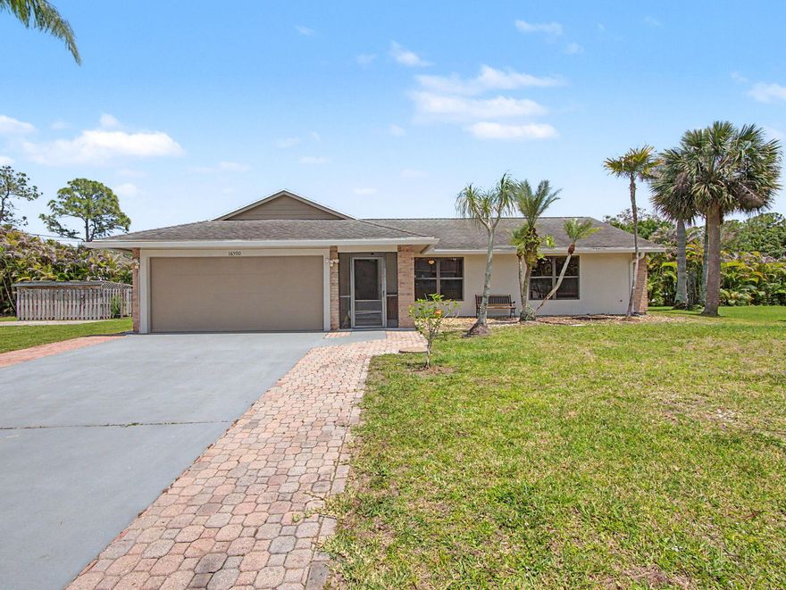 Nestled on a spacious 1.25-acre corner lot in the highly desirable non-HOA community of Jupiter Farms, this 3-bedroom, 2-bathroom home with a 2-car garage offers the freedom and privacy you've been searching for, with no restrictions, so bring all the toys, RVs, boats, and more!  Inside, you'll find elevated ceilings, laminate and tile flooring throughout, freshly painted interiors, a dedicated dining space, and walk-in closets in all bedrooms. The updated bathrooms add a modern touch, while the kitchen features stainless steel appliances and overlooks the main living areas, creating a functional and inviting layout.  Major 2021 updates provide peace of mind, including updated A/C ductwork A/C system hot water heater, well, water system, and new garage door springs.  The washer and dryer were replaced in 2023.  Step outside and enjoy true Florida living with a fully fenced yard featuring 3 gates, a screened and covered front porch, and a screened and covered patio complete with retractable shades. Additional exterior features include a painted driveway, gutters, updated walkway, RV hookup, house generator hookup, storage shed, and newer exterior paint. This rare Jupiter Farms property combines acreage living, modern updates, and endless possibilities!