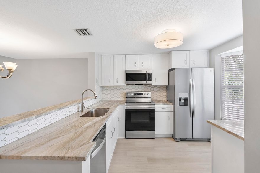 Stunning updated Townhome in Pompano Beach, FL! Newly remodeled Kitchen, Luxury Vinyl Flooring, Waterview and much more! New Kitchen tastefully designed w/ white shaker cabinets, granite countertops, and crisp white backsplash. Private patio overlooking the pond. Half-bath on first floor. Double master/primary bedrooms upstairs. Amazing restaurants nearby and only 2.5 miles to the Pompano Beach Pier!  **No Polybutylene pipes, they were all replaced. All ages welcome. Large pets welcome with a maximum of two dogs per unit. Two car limit per unit. Rent right away - an investors dream! Minimum lease 4 months.