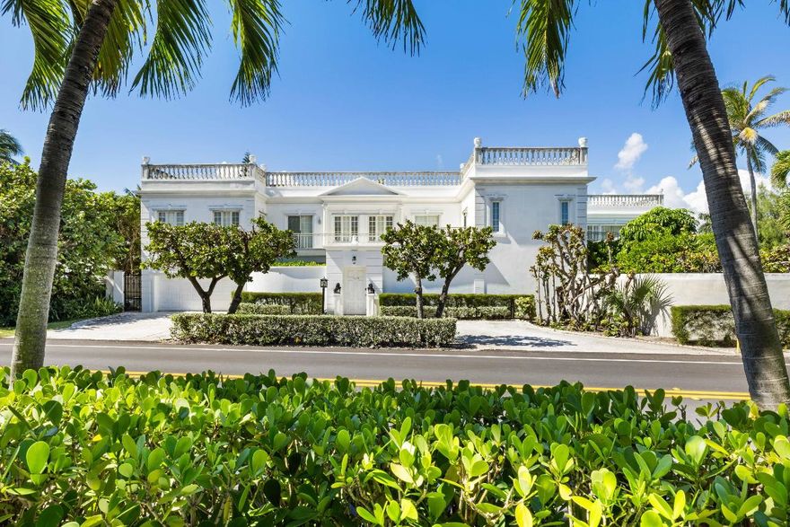 Sited within the Presidential Security Zone just two streets north of Mar-a-Lago, this elegant John Volk-designed Regency home offers timeless Palm Beach appeal with private deeded beach access and sweeping ocean views. Featuring five bedrooms, six full and two half baths, the residence includes two oceanview balconies and a 40-by-20-foot lap pool surrounded by manicured gardens. Perfect for entertaining or as a serene seaside retreat, the property presents an exceptional opportunity to reimagine, renovate, or build a dream home in the prestigious Estate Section—steps from the sand and minutes from Worth Avenue.