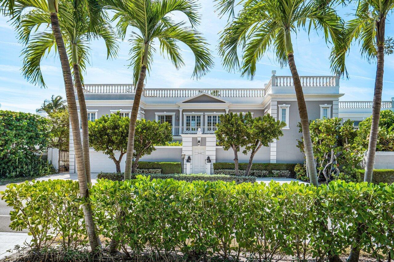 Beautiful John Volk Regency home with ocean views and beach access. Just three streets North of Mar-a-Lago in the Estate Section, this five bedroom, six full and two half bathroom home is ideal for entertaining. A 40 x 20 foot pool and two upstairs balconies with direct ocean views. Just steps away from a private beach deeded beach access.