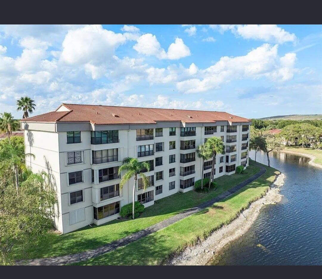 All hurricane impact windows, new A/C, hot water heater (2023), two new bathrooms, new flooring, serene water view, newer washer/dryer. Freshly painted with an open contemporary design. Community has many amenities including an athletic club, tennis courts, pickleball courts, basketball courts a theater, grand ballroom, Olympic-sized pool. Great location close to beaches, shopping grocery stores and ''A'' rated hospitals. Price has been slashed for fast sale!
