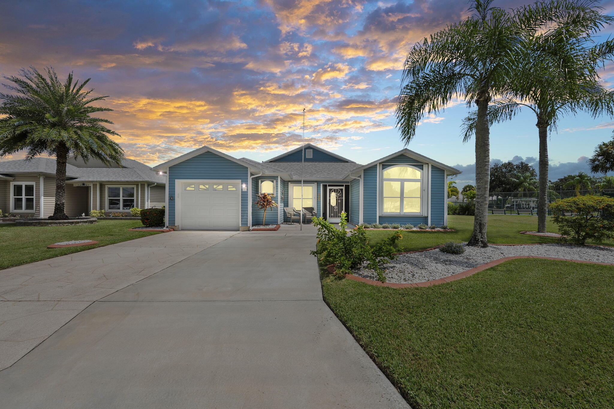 Location, location, location!! This is the one you have been waiting for. The closest lakefront home, within walking distance to the clubhouse & pool & no neighbors to the right! Totally turnkey & ready to move into. Newly painted inside/out. New electrical panel. Concrete block construction w/ alum siding, 2021 roof & gutters, full accordion shutters. AC 5 yr, HWH 2 yr. Custom landscape concrete edging. Tile throughout. Vaulted ceilings. Updated bathrooms. Full kitchen remodel w/ quartz, soft close features, stainless steel appliances & double oven feature, under cabinet lighting. Updated lighting/fans throughout. Palm Grove is a 55+ community with a lakeside, year round heated pool, tennis, bocce, pickleball, billiards & so much more along with an active community schedule.