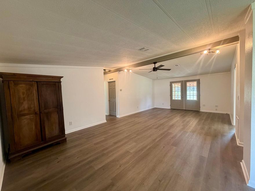 Recently remodeled 3-bedroom, 2-bath manufactured home located on a quiet street with plenty of space and storage! This home features a large open living area with a formal dining room, perfect for entertaining or gatherings. Recent updates include a beautifully remodeled kitchen, updated bathrooms, new flooring, and fresh paint throughout. Enjoy relaxing outdoors with two porches, including one screened porch for year-round comfort. The property is connected to city water and also includes a private well for added convenience. Additional features include a shipping container for extra storage and plenty of room for all your tools, equipment, or hobbies. Move-in ready and packed with upgrades!