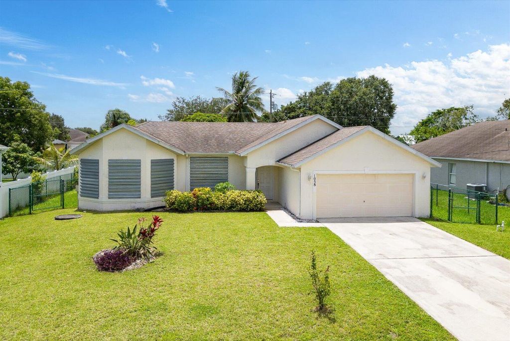 Photo of 1058 SW Locke Avenue, Port Saint Lucie, FL 34953 (MLS # R11109743)