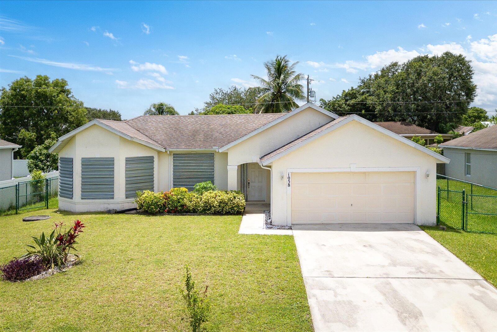 Welcome to this beautifully maintained 4-bedroom, 2-bathroom single-family home available for rent, located in the heart of Port Saint Lucie. This home features an attractive combination of tile and carpet flooring throughout. The modern kitchen is fully equipped with appliances, including a refrigerator, range, and dishwasher, complemented by elegant wooden cabinets. The spacious master bedroom includes a luxurious bathroom with a combo tub and shower. Enjoy a bright and airy living area perfect for relaxation and entertaining. Centrally located, this home is just minutes from supermarkets, highways, shopping centers, restaurants, and more. Schedule your private tour today and experience the comfort of your new home!