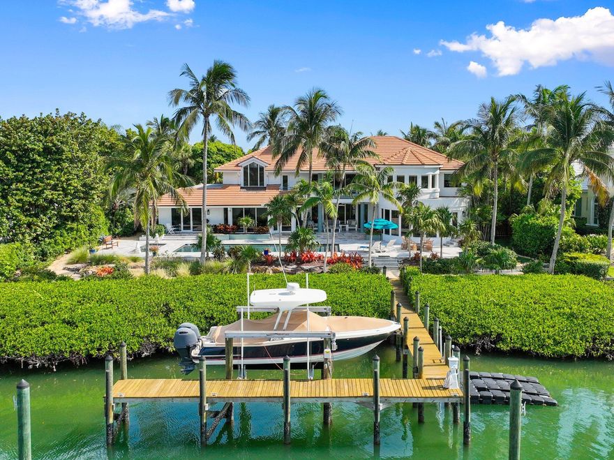 Discover this expansive Waterfront Estate located on a secluded barrier island in prestigious Sailfish Point Country Club. Enjoy stunning views, turquoise waters, 127 ft of waterfront & welcome guests by yacht at your private dock. Completely reimagined, the home blends timeless elegance w/ modern coastal luxury after a complete renovation in 2022. The chef's kitchen features high-end appliances, quartz counters, a large walk-in butler's pantry & panoramic views. The primary suite offers his-&-her spa-like baths with dual walk-in closets & expansive views. An elevator was added along with an additional bay garage- 4-car garage + 2 golf carts makes this home perfect for any car enthusiasts. Boaters will love the deep-water access, 16K lb lift & pilings for a large vessel.